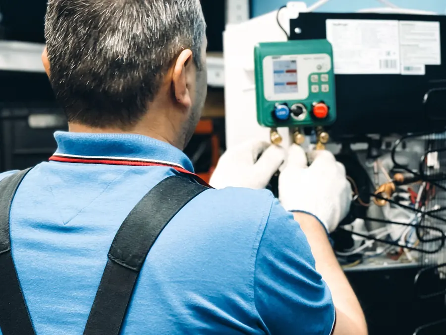 HVAC technician working on air conditioning equipment