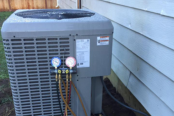 Technician servicing an air conditioning unit