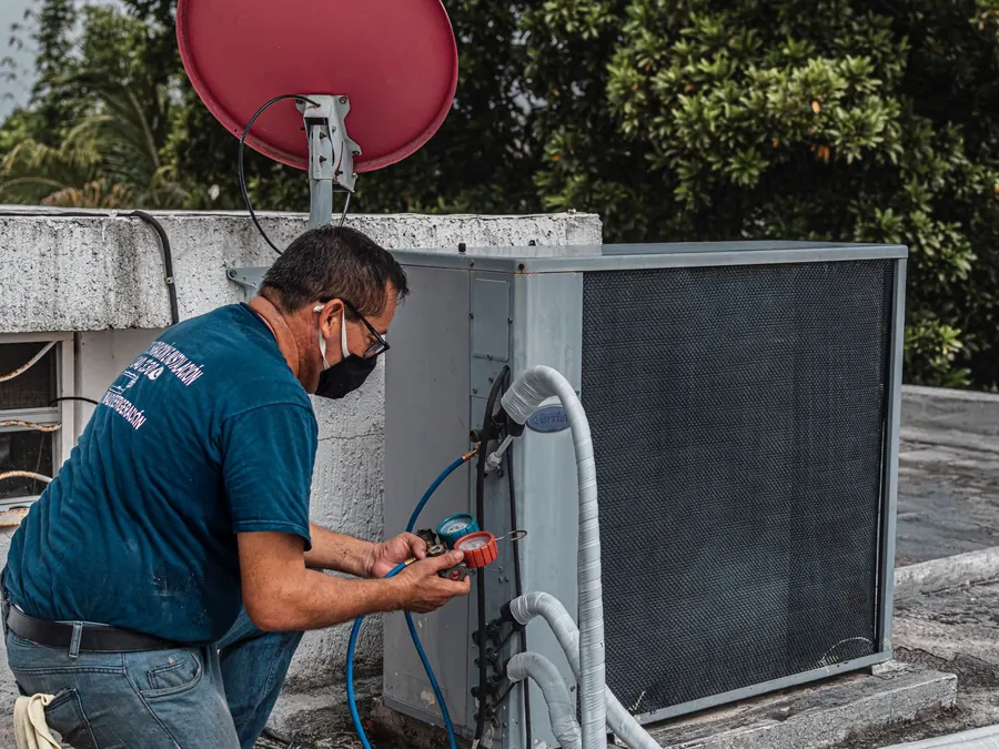HVAC technician checking service equipment